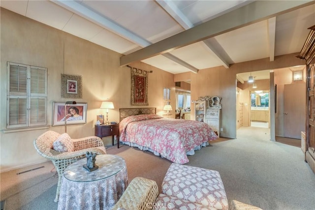 5646 E Park Circle Dr, Fresno, CA 93727 - bedroom with beam ceiling, carpet floors, multiple windows, and ensuite bath