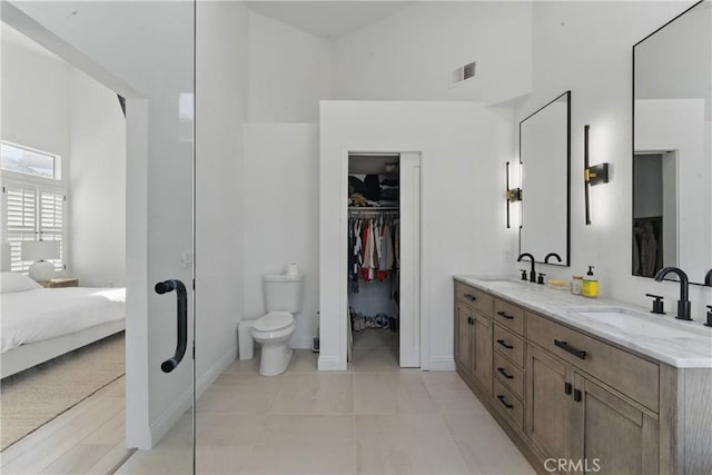 3381 Deaver Dr, Corona, CA 92882 - ensuite bathroom featuring double vanity, visible vents, a towering ceiling, and a sink