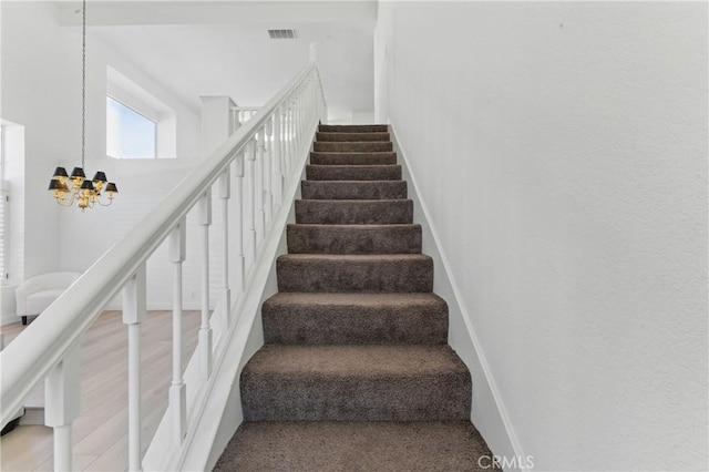 3381 Deaver Dr, Corona, CA 92882 - stairway featuring baseboards, visible vents, and a chandelier