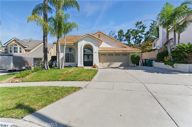3381 Deaver Dr, Corona, CA 92882 - mediterranean / spanish home with a tiled roof, a front lawn, stucco siding, driveway, and a garage