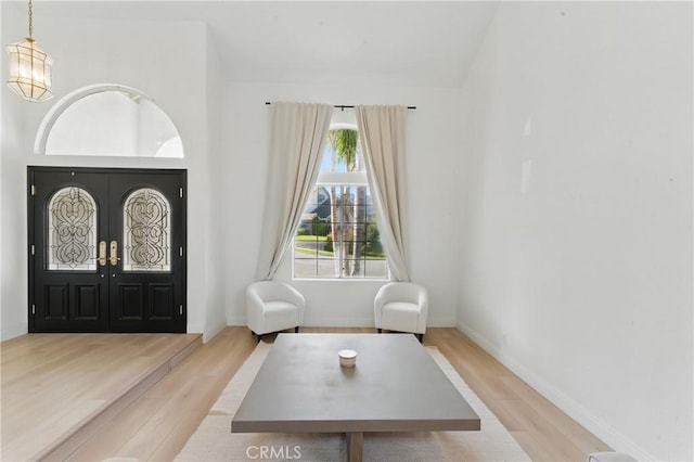 3381 Deaver Dr, Corona, CA 92882 - foyer with baseboards, wood finished floors, and an inviting chandelier