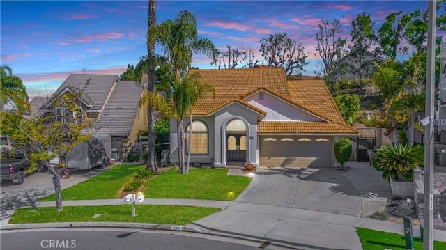 3381 Deaver Dr, Corona, CA 92882 - mediterranean / spanish home featuring a tile roof, a front lawn, concrete driveway, a garage, and stucco siding