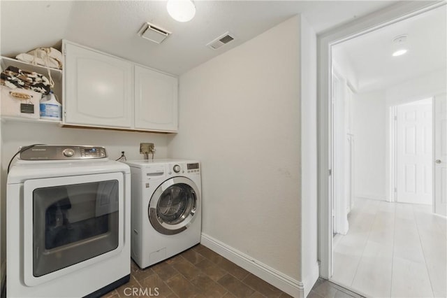 3381 Deaver Dr, Corona, CA 92882 - laundry area with cabinet space, visible vents, washing machine and clothes dryer, and baseboards