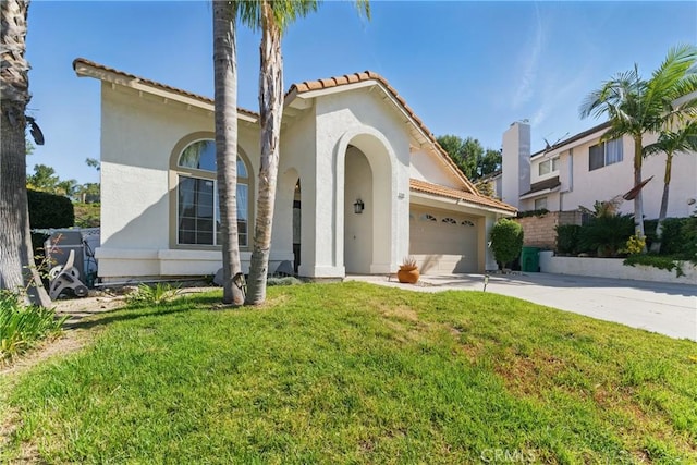 3381 Deaver Dr, Corona, CA 92882 - mediterranean / spanish house with a tile roof, concrete driveway, a front lawn, an attached garage, and stucco siding
