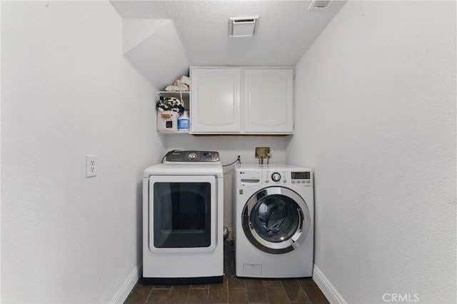 3381 Deaver Dr, Corona, CA 92882 - clothes washing area with washing machine and clothes dryer, baseboards, visible vents, and cabinet space