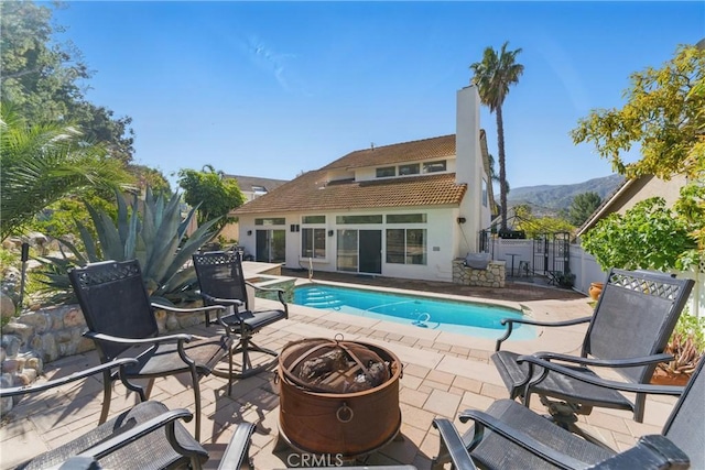3381 Deaver Dr, Corona, CA 92882 - view of pool with a storage structure, an outdoor fire pit, an outdoor structure, a patio, and a fenced in pool