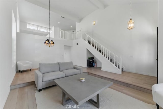 3381 Deaver Dr, Corona, CA 92882 - living room featuring wood finished floors, beamed ceiling, baseboards, a chandelier, and high vaulted ceiling