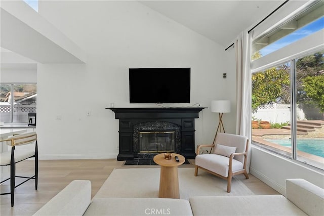 3381 Deaver Dr, Corona, CA 92882 - living room featuring a fireplace, vaulted ceiling, a healthy amount of sunlight, and light wood-type flooring