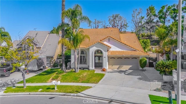 3381 Deaver Dr, Corona, CA 92882 - mediterranean / spanish house with a tile roof, a garage, concrete driveway, a front yard, and stucco siding
