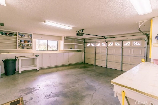 garage with a garage door opener and visible vents