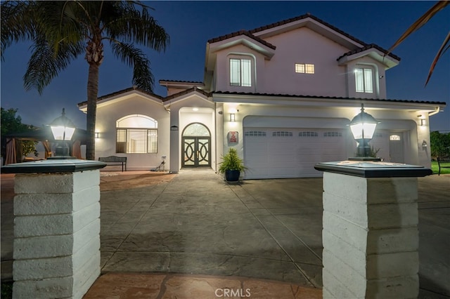 11310 Wentworth St, Sun Valley, CA 91352 - mediterranean / spanish-style home with stucco siding, a tile roof, driveway, and an attached garage