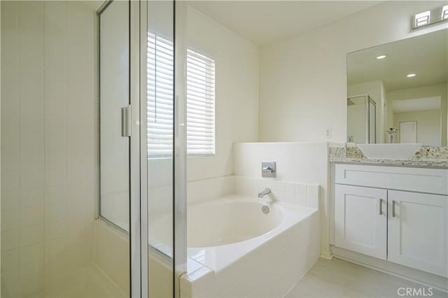 15255 Sunny Point St, Victorville, CA 92394 - full bathroom with a stall shower, plenty of natural light, a bath, and vanity