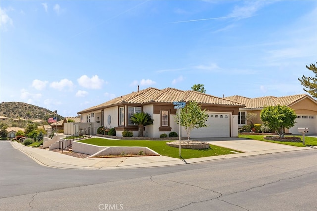 6112 Turnberry Dr, Banning, CA 92220 - view of front of property with concrete driveway, stucco siding, an attached garage, and a tile roof
