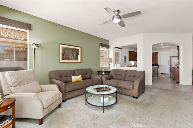 6112 Turnberry Dr, Banning, CA 92220 - living area featuring light colored carpet, a ceiling fan, and arched walkways