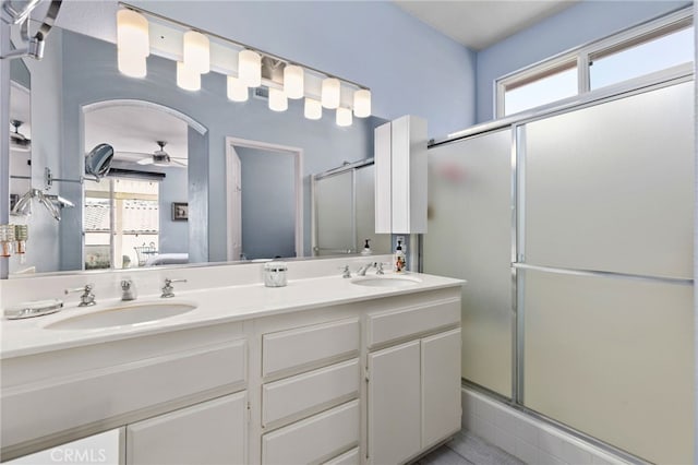 6112 Turnberry Dr, Banning, CA 92220 - ensuite bathroom with double vanity, a sink, a ceiling fan, and a stall shower