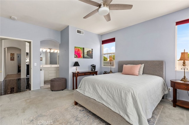 6112 Turnberry Dr, Banning, CA 92220 - carpeted bedroom with arched walkways, a ceiling fan, visible vents, and ensuite bathroom