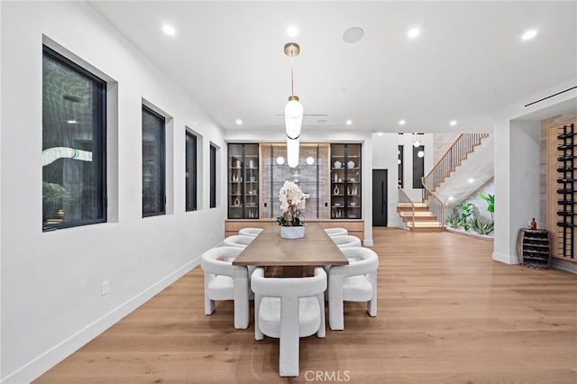 dining room featuring stairway, baseboards, light wood-type flooring, and recessed lighting