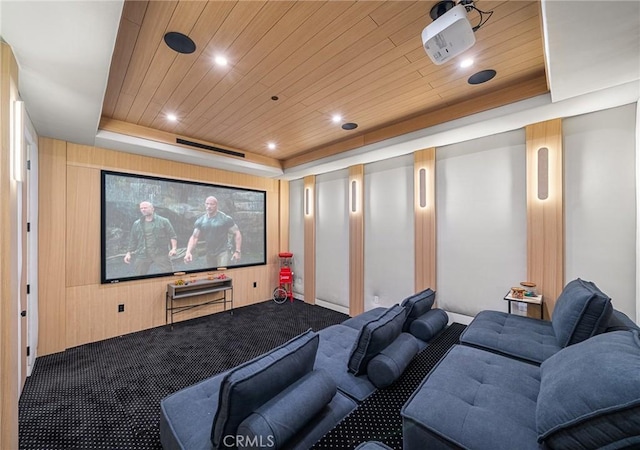 home theater with a tray ceiling, carpet flooring, wooden ceiling, and recessed lighting