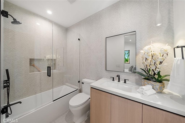 full bath featuring enclosed tub / shower combo, toilet, and vanity