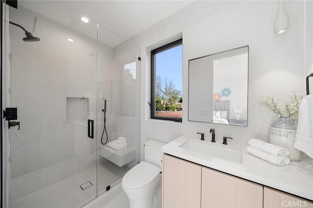 full bathroom featuring vanity, toilet, and a stall shower