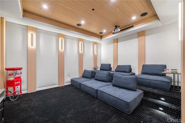 cinema room with wood ceiling, carpet flooring, a tray ceiling, and recessed lighting