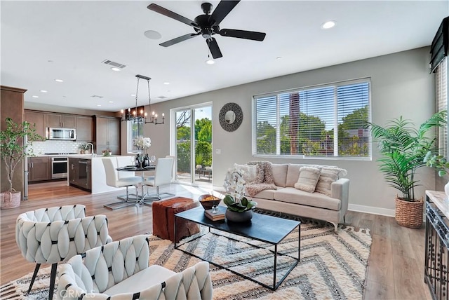 23206 W Remington Way, West Hills, CA 91307 - living room with ceiling fan with notable chandelier, visible vents, and recessed lighting