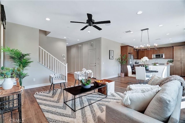 23206 W Remington Way, West Hills, CA 91307 - living room featuring baseboards, visible vents, recessed lighting, ceiling fan with notable chandelier, and stairway