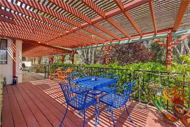 deck with a pergola and outdoor dining space