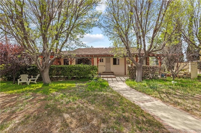 ranch-style house with a front lawn