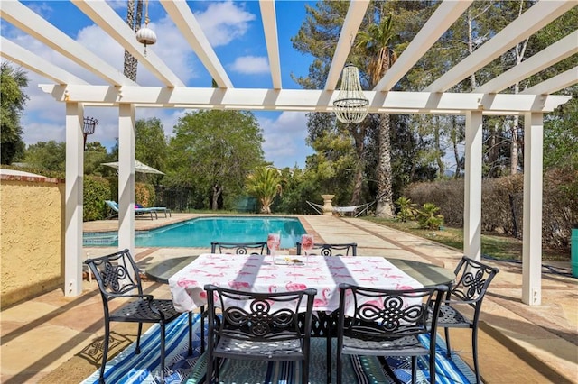 pool with a pergola, outdoor dining space, and a patio