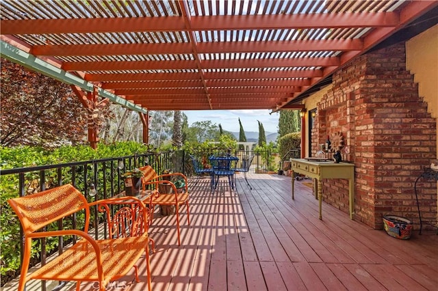 deck featuring a pergola, a mountain view, and outdoor dining area