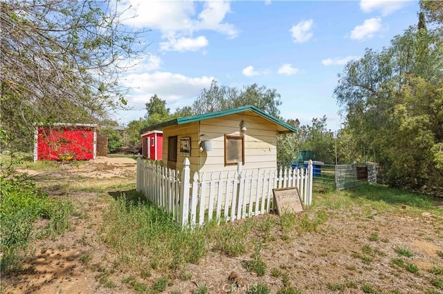 view of outdoor structure with fence