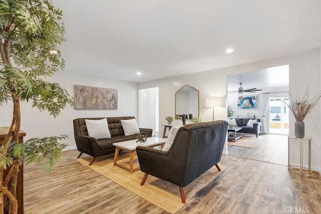 living room featuring recessed lighting, baseboards, ceiling fan, and wood finished floors