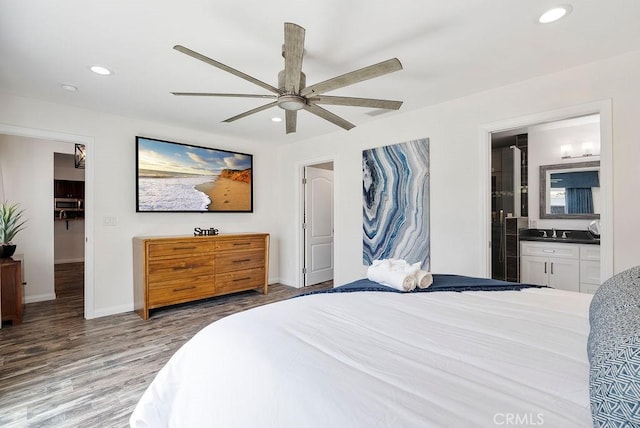 bedroom with connected bathroom, recessed lighting, baseboards, a ceiling fan, and wood finished floors