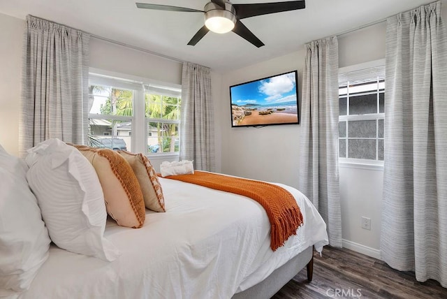 bedroom with baseboards, ceiling fan, and wood finished floors