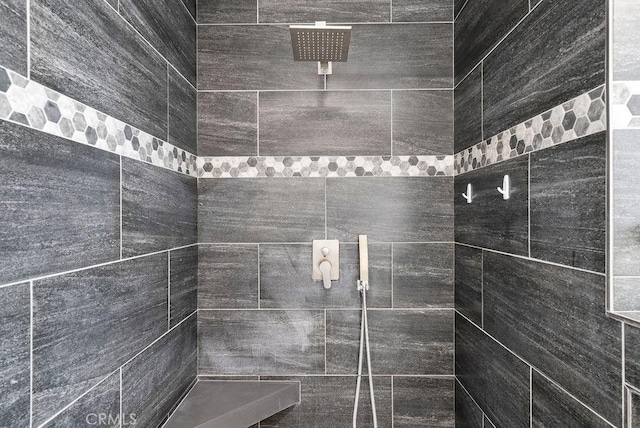 bathroom with a tile shower