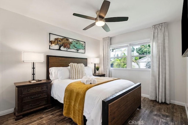 bedroom with baseboards, ceiling fan, and wood finished floors