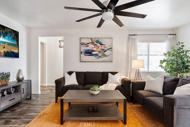 living room with baseboards, a ceiling fan, and wood finished floors