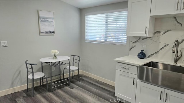 2108 Raleigh Ave, Costa Mesa, CA 92627 - kitchen featuring a sink, baseboards, dark wood finished floors, and white cabinetry