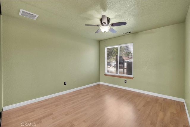 19501 Kinai Rd, Apple Valley, CA 92307 - spare room with baseboards, wood finished floors, visible vents, and a textured ceiling