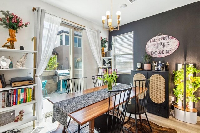 dining space featuring a chandelier and wood finished floors