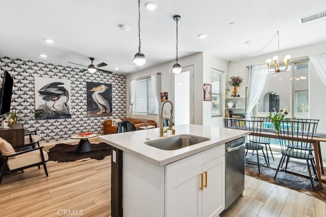 3630 E Peckham Paseo Unit 4, Ontario, CA 91761 - kitchen featuring a sink, dishwasher, light wood-style floors, a ceiling fan, and light countertops