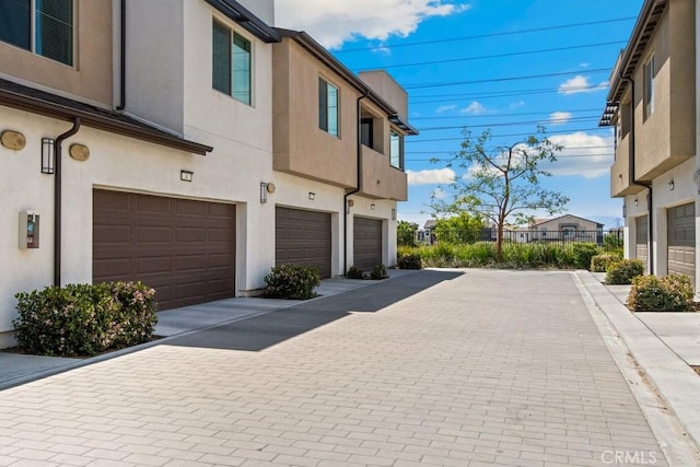 3630 E Peckham Paseo Unit 4, Ontario, CA 91761 - view of side of property featuring an attached garage and stucco siding