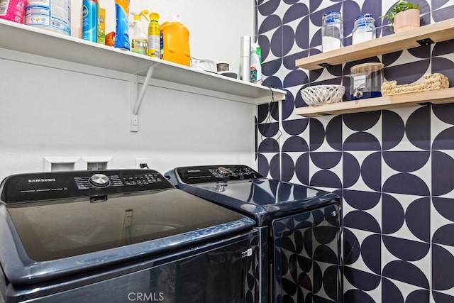 clothes washing area featuring independent washer and dryer and laundry area