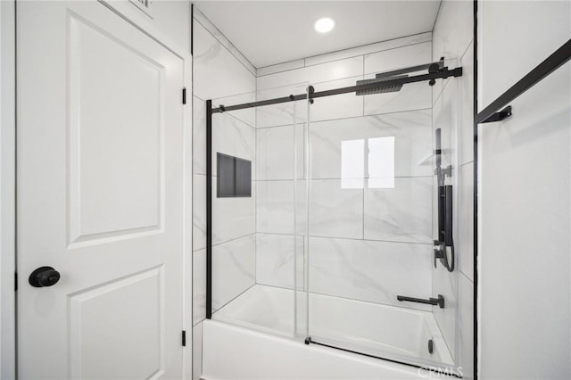 bathroom featuring enclosed tub / shower combo and recessed lighting