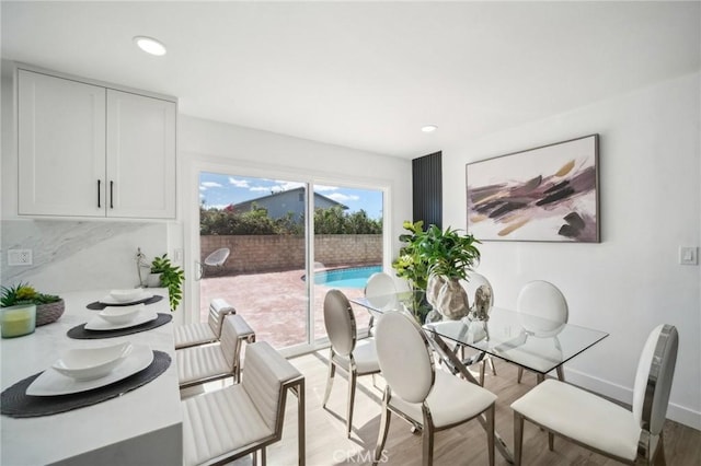 dining area featuring light wood-style flooring and recessed lighting