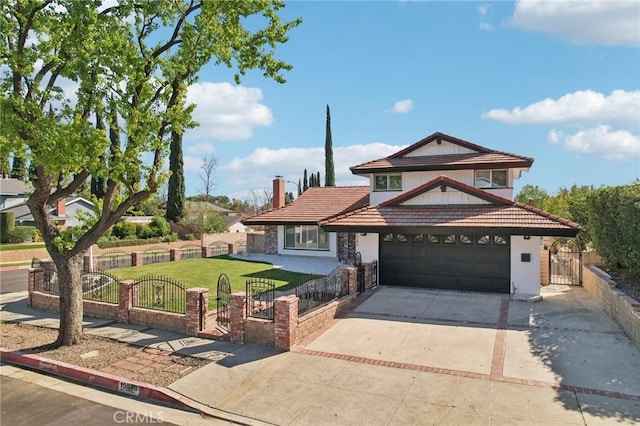 traditional-style house featuring a gate, a fenced front yard, a chimney, and concrete driveway