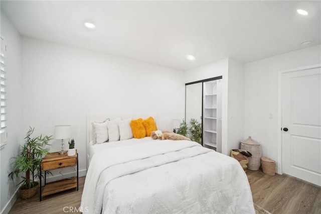 bedroom featuring recessed lighting and light wood-type flooring