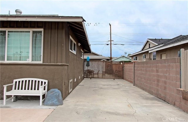 8037 Cactus Cir, Buena Park, CA 90620 - view of side of property featuring board and batten siding, fence, a patio, and stucco siding
