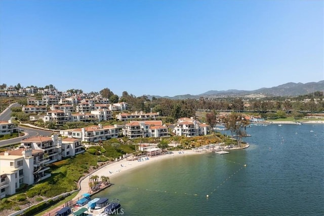 drone / aerial view featuring a water and mountain view